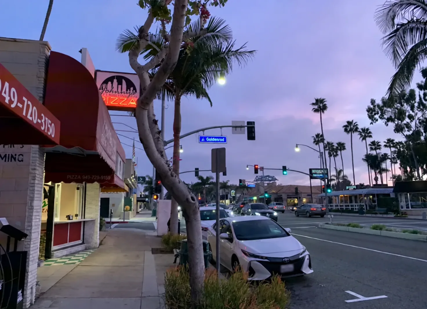 California commercial street with parked and moving vehicles