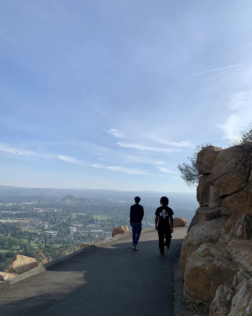 Two people walking along an elevated California trail